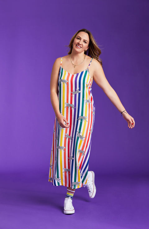 A lady wearing a pride sleeveless long maxi dress with prowling pattern.
