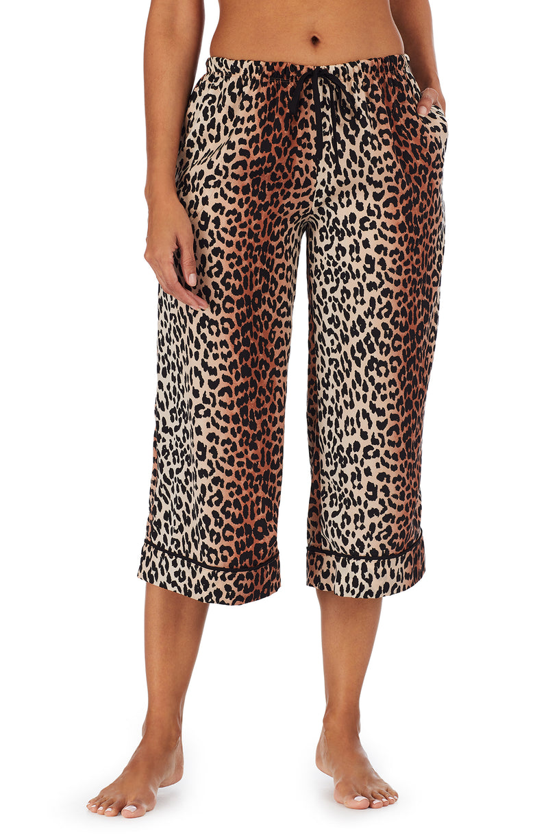 Bottom part f a girl wearing a short sleeve crop pant with leopard skin pattern.