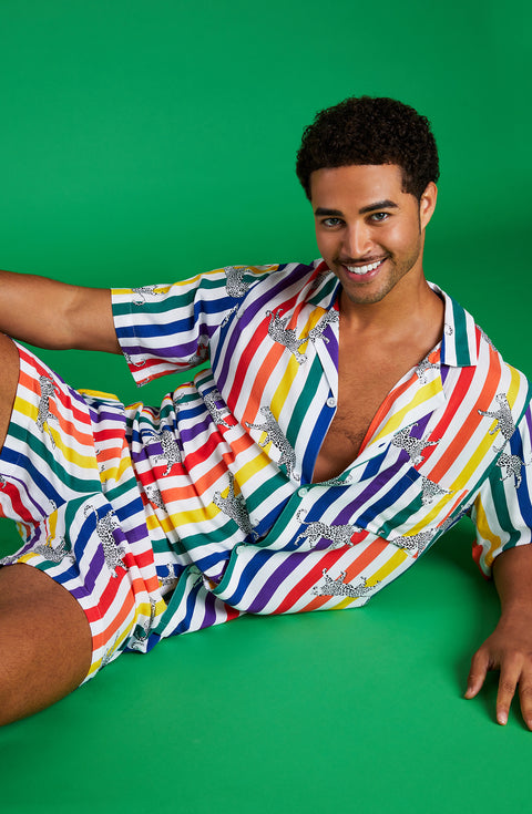 A man wearing a pride short sleeve pj set with prowling pattern.