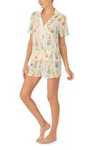 A lady wearing tan short sleeve pj set with florence print