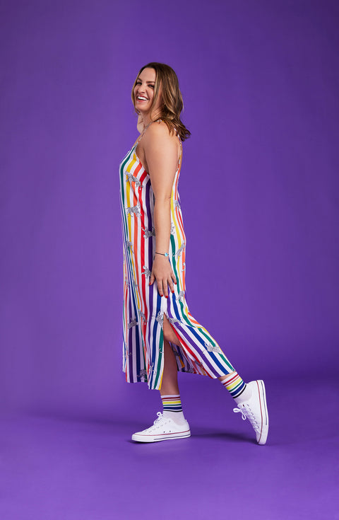 A lady wearing a pride sleeveless long maxi dress with prowling pattern.