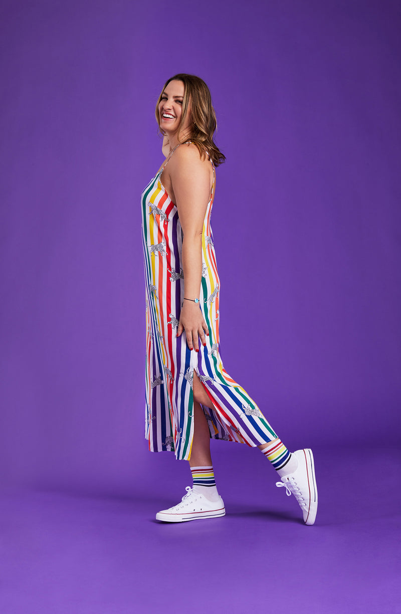 A lady wearing a pride sleeveless long maxi dress with prowling pattern.