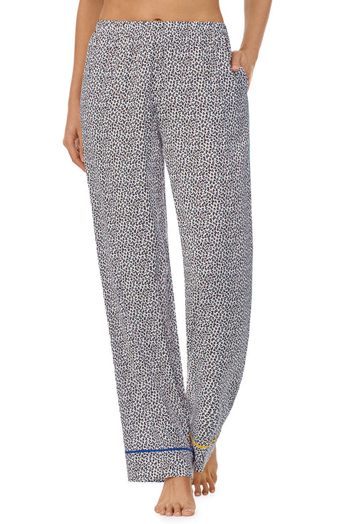 A lady wearing a long pj pant with black and white feline pride pattern.