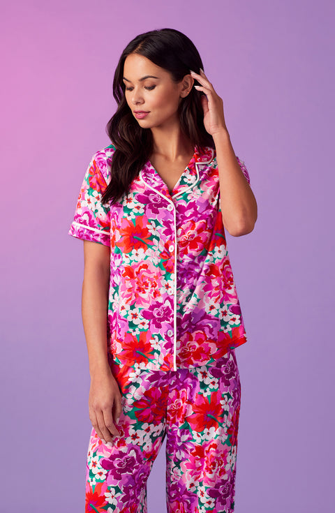 A lady wearing purple short sleeve soho pj set with magenta meadow print.