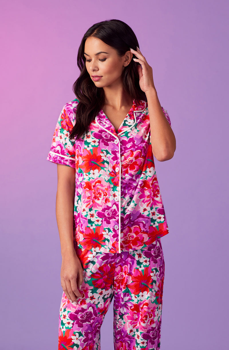A lady wearing purple short sleeve soho pj set with magenta meadow print.
