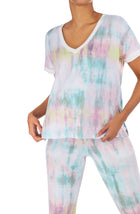 Upper body of a girl wearing short sleeve pajama sets with multi colour tie dye design.