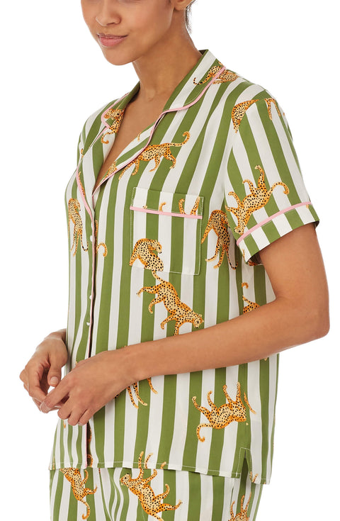 A girl wearing short sleeve top with cheetahs and stripe design.