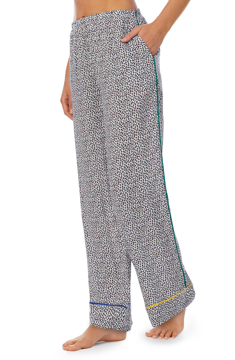 A lady wearing a long pj pant with black and white feline pride pattern.