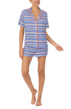 A lady wearing a short sleeve boxer pajama set with azul stripes.