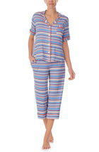 A lady wearing a short sleeve crop pajama set with azul stripes.