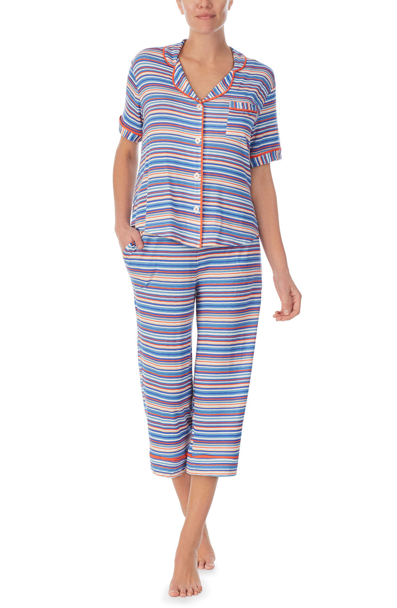A lady wearing a short sleeve crop pajama set with azul stripes.
