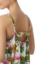 A lady wearing white sleeveless bella pj set with aloha palm print.