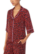 A lady wearing a elbow sleeve gramercy top with rustic animal pattern.