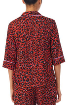 A lady wearing a elbow sleeve gramercy top with rustic animal pattern.