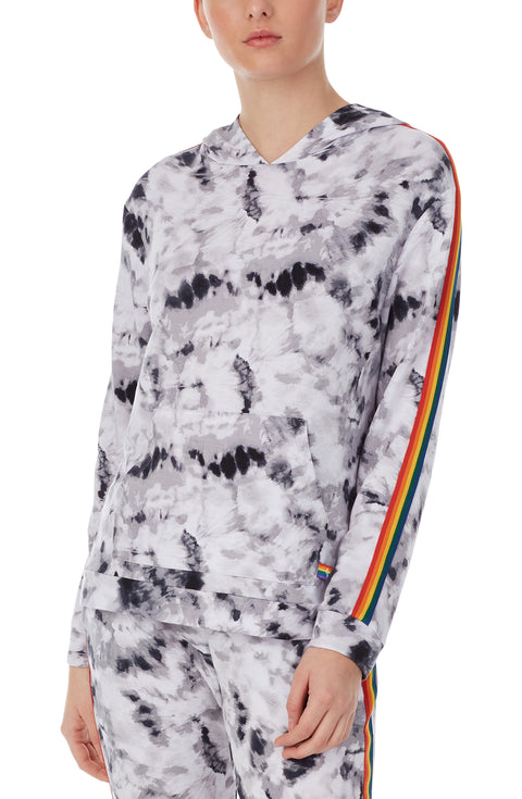 A lady wearing a long sleeve reese unisex hoodie with black and white tiedye with pride stripes in side.