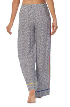 A lady wearing a long pj pant with black and white feline pride pattern.