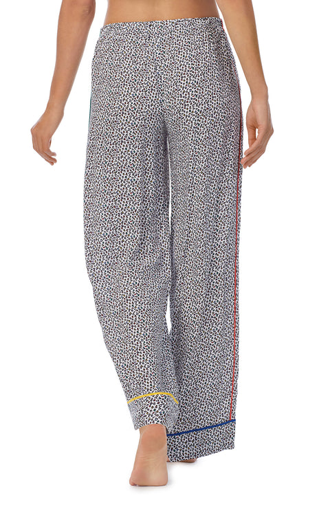 A lady wearing a long pj pant with black and white feline pride pattern.