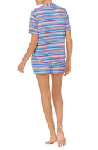 A lady wearing a short sleeve boxer pajama set with azul stripes.