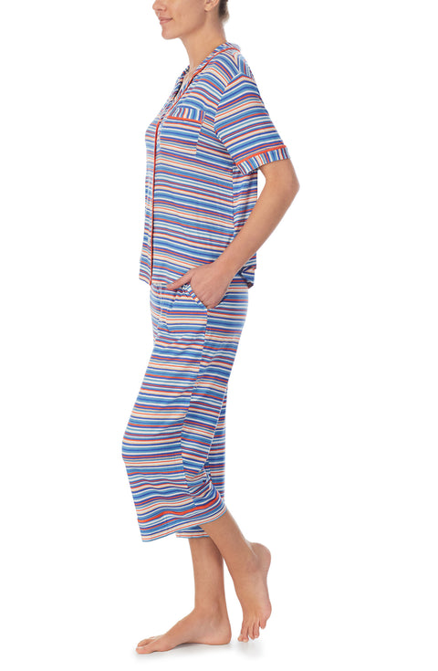 A lady wearing a short sleeve crop pajama set with azul stripes.