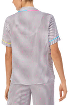 A lady wearing a short sleeve top with silver stripes.