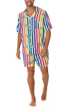 A man wearing a pride short sleeve pj set with prowling pattern.
