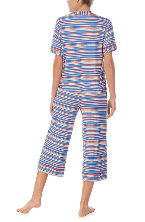 A lady wearing a short sleeve crop pajama set with azul stripes.