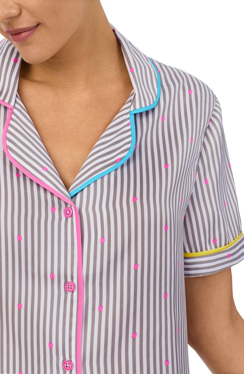 A lady wearing a short sleeve top with silver stripes.