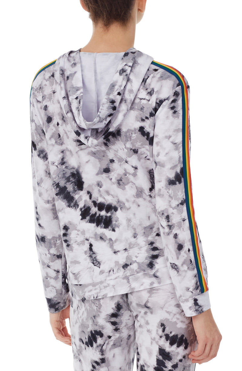 A lady wearing a long sleeve reese unisex hoodie with black and white tiedye with pride stripes in side.
