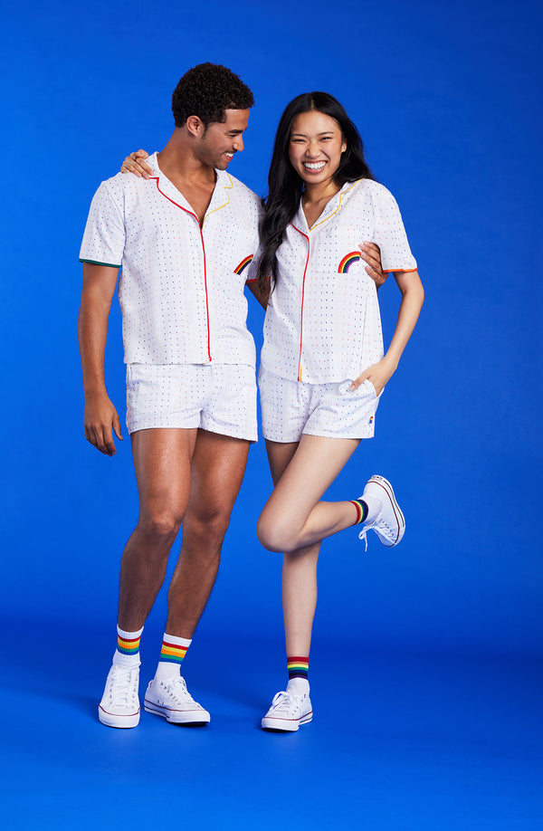 A lady and a man wearing a white unisex pj set with midnight lightning pattern.