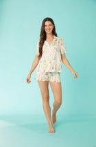 A lady wearing tan short sleeve pj set with florence print