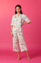 A lady wearing multi color short sleeve tilden pj set with catching waves print.