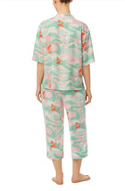 A lady wearing multi color short sleeve tilden pj set with catching waves print.