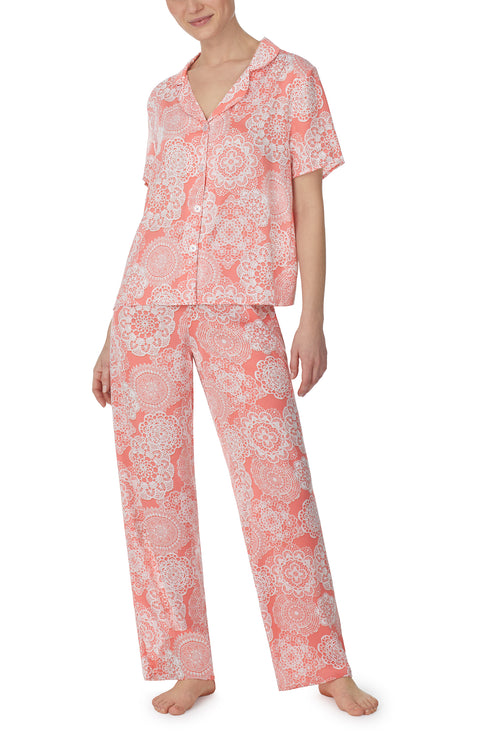 A lady wearing pink short sleeve madison pj set with spring lace print.