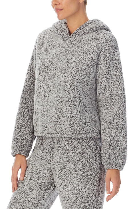 A lady wearing a frosted grey long sleeve top.