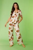 A lady wearing white short sleeve madison pj set with chic cheetah print.