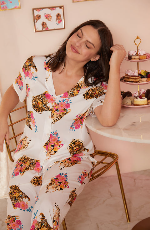 A lady wearing white short sleeve madison pj set with chic cheetah print.