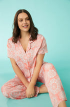 A lady wearing pink short sleeve madison pj set with spring lace print.