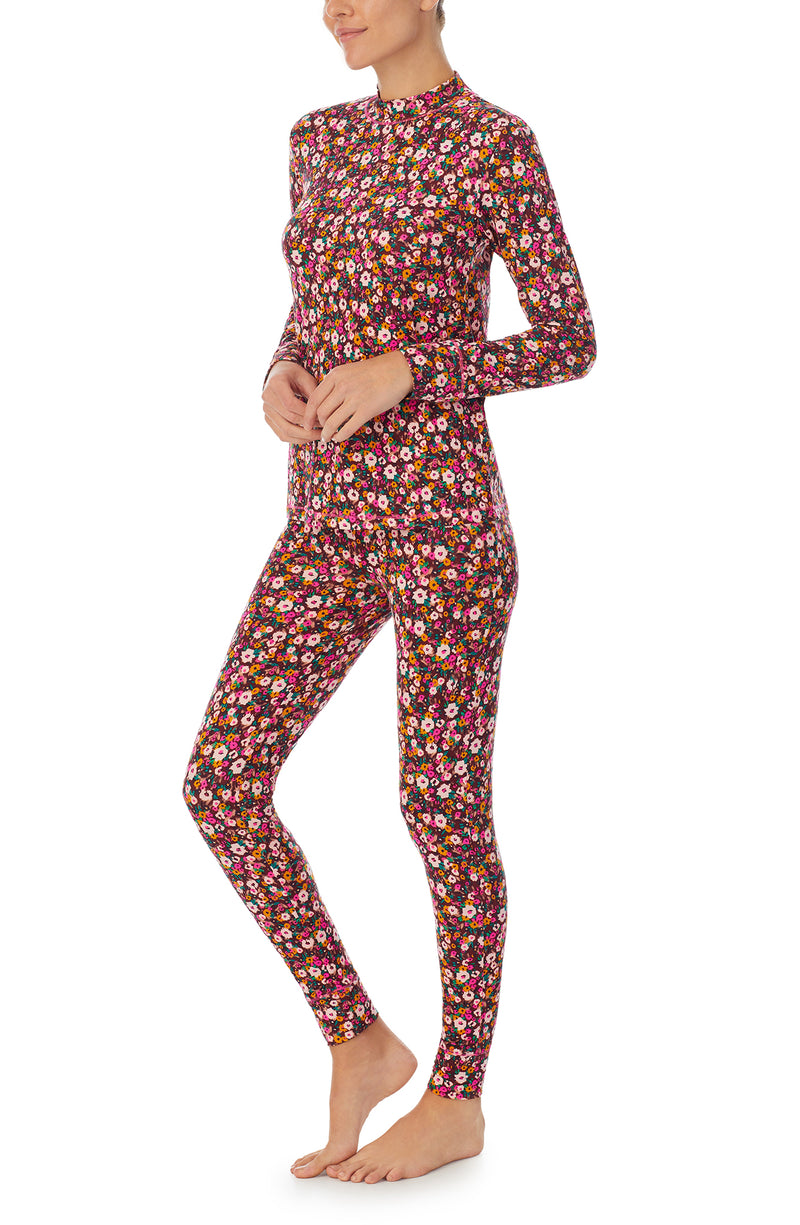 A lady wearing a long sleeve gemma pj set with disty floral pattern.