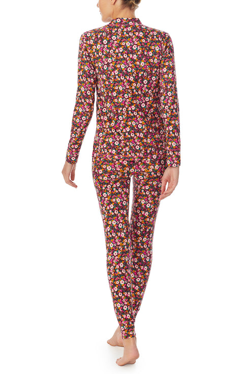 A lady wearing a long sleeve gemma pj set with disty floral pattern.