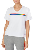 A lady wearing a white unisex T-Shirt with pride stripes.