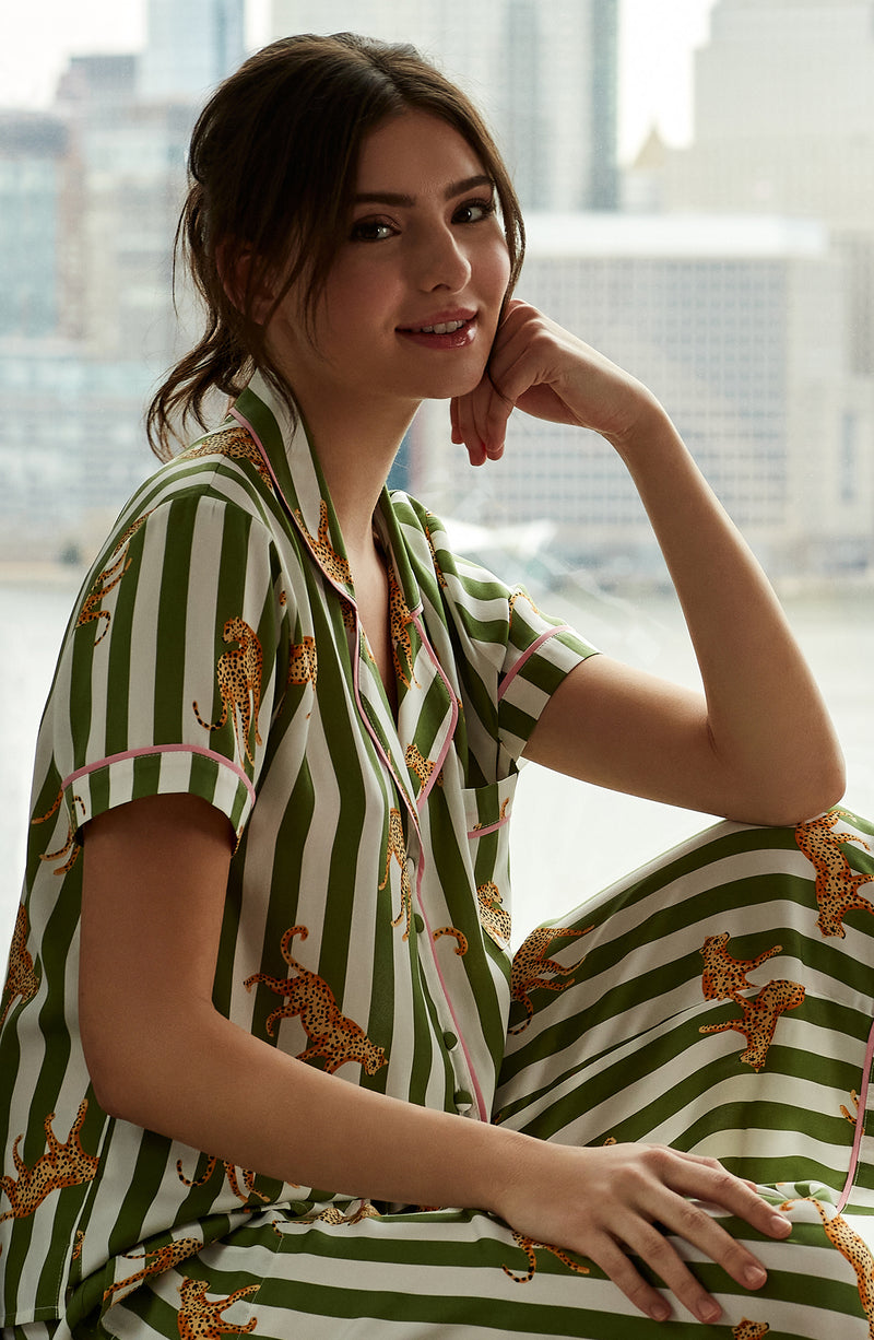 A girl wearing short sleeve top with cheetahs and stripe design.