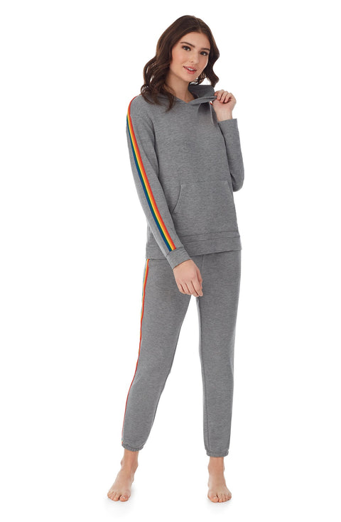 A lady wearing a grey long sleeve unisex reese hoodie with pride stripes in side.