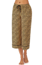 Bottom part f a girl wearing a crop pant with leopard skin pattern.