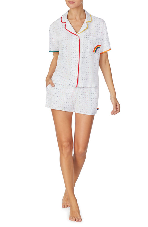 A lady wearing a white unisex pj set with midnight lightning pattern.