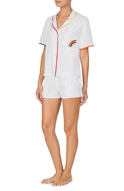 A lady wearing a white unisex pj set with midnight lightning pattern.